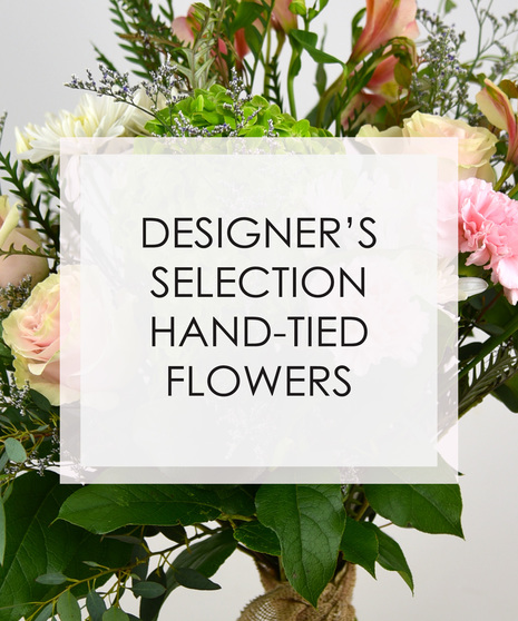 A hand-tied bouquet wrapped in natural paper and raffia,  with designer’s choice of seasonal flowers and foliage,  customers can pick between pastel or vibrant colors.